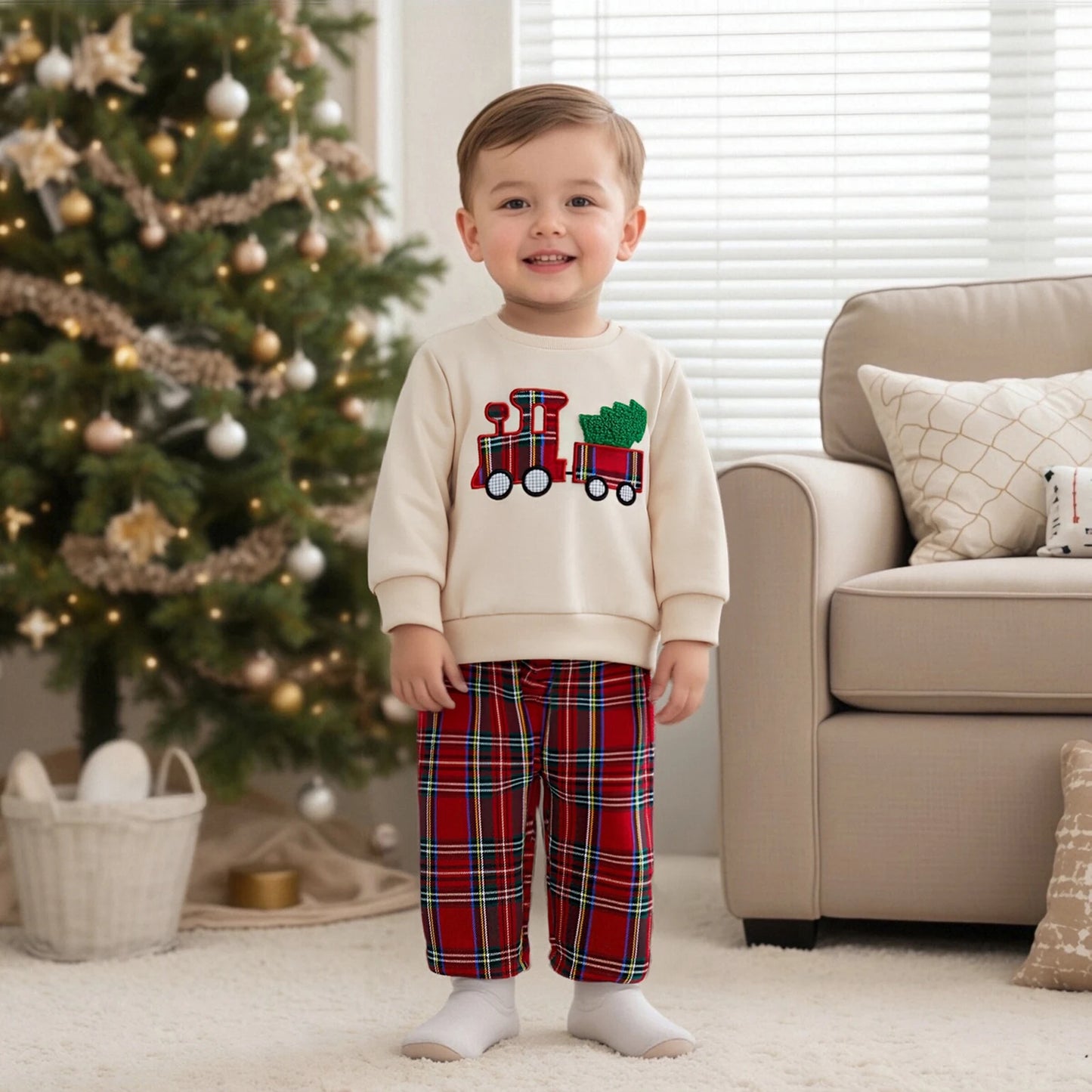 petit garçon devant un sapin de noël avec une tenue de noël bébé garçon en coton avec pantalon carreaux rouges