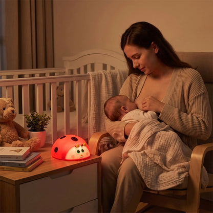 maman qui allaite son bébé avec une veilleuse bébé coccinelle pour favoriser  l'endormissement